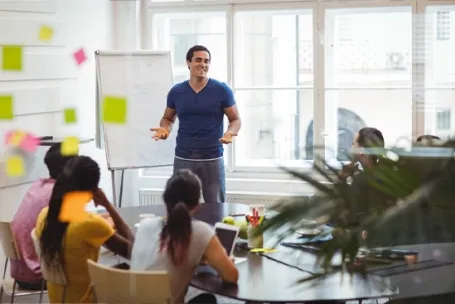 formateur qui teste la conception de sa formation devant des collègues